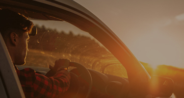 Image of car driving down the road with Bridgestone text referring to how to buy car tyres.