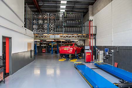 Car in the workshop receiving a qualified car logbook service & repair service for the logbook car warranty.