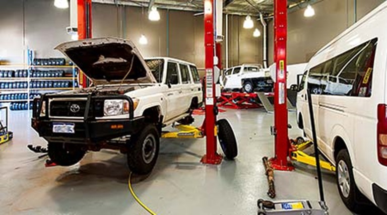 Car mechanic and auto repair shop, with image showing cars being serviced at Bridgestone.
