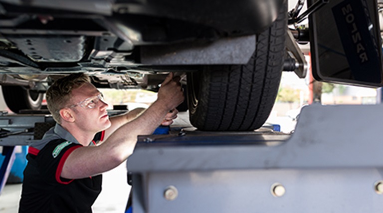 Find a store near you for your wheel alignment service. Image of a wheel alignment on a car.