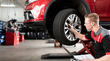Quality tyres image of a tyre fitter servicing a car tyre